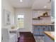 Quaint kitchenette features updated cabinets, butcher block countertops, and black-and-white tile flooring at 737 Johnson Ave, Lakeland, FL 33801
