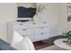 Living room boasts a stylish white dresser with gold hardware, accented with modern art and a sleek design at 737 Johnson Ave, Lakeland, FL 33801