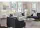 Bright living room featuring neutral paint, white sofa, cozy armchairs, and a decorative round coffee table at 737 Johnson Ave, Lakeland, FL 33801