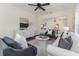 Open-concept living room boasts large windows, neutral tones, hardwood floors, and stylish furnishings at 737 Johnson Ave, Lakeland, FL 33801