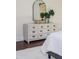 Main bedroom features a dresser with an arched mirror and a decorative monstera leaf plant at 737 Johnson Ave, Lakeland, FL 33801