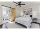 Comfortable main bedroom with en-suite bathroom featuring a sliding barn door at 737 Johnson Ave, Lakeland, FL 33801