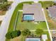 Aerial view showcasing a backyard with a screened pool and a lush lawn, perfect for outdoor enjoyment at 7890 Ashford Dr, Lakeland, FL 33810