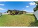 Expansive backyard features a screened-in lanai and lush green lawn, perfect for outdoor living at 7890 Ashford Dr, Lakeland, FL 33810