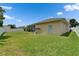 Spacious backyard featuring a screened lanai, mature landscaping, and a white vinyl fence at 7890 Ashford Dr, Lakeland, FL 33810
