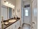 Bright bathroom with granite counters, white cabinets, and a convenient door to the exterior, great for pool access at 7890 Ashford Dr, Lakeland, FL 33810