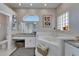 Well-lit bathroom with dual vanities, a luxurious soaking tub, and tasteful decor, creating a relaxing space at 7890 Ashford Dr, Lakeland, FL 33810