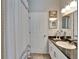 Clean bathroom with a modern vanity and a shower/tub combination featuring a decorative shower curtain at 7890 Ashford Dr, Lakeland, FL 33810