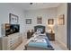 Cozy bedroom featuring a television and a dresser, ideal for relaxing and unwinding after a long day at 7890 Ashford Dr, Lakeland, FL 33810