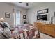 Comfortable bedroom features a wood framed bed, ceiling fan, and a wooden dresser with a TV at 7890 Ashford Dr, Lakeland, FL 33810