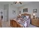 Bedroom with a wood bed frame, ceiling fan, and dresser featuring a warm and inviting atmosphere at 7890 Ashford Dr, Lakeland, FL 33810