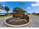 Charming brick entrance sign for the Canterbury community with manicured landscaping and an American flag at 7890 Ashford Dr, Lakeland, FL 33810
