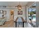 Open dining area with backyard views, showcasing a wooden table, bright white chairs and a modern chandelier at 7890 Ashford Dr, Lakeland, FL 33810