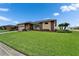 Beautifully landscaped front yard of a charming single-story home with mature trees and a driveway at 7890 Ashford Dr, Lakeland, FL 33810