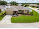 Well-maintained single-story home featuring lush green lawn, attractive landscaping, and a paved driveway at 7890 Ashford Dr, Lakeland, FL 33810