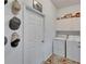 Bright laundry room featuring a side-by-side washer and dryer, with overhead cabinets, and some decorative art at 7890 Ashford Dr, Lakeland, FL 33810