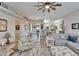 Open concept living area boasts recessed lighting, ceiling fan, hardwood floors and comfortable seating, great for entertaining guests at 7890 Ashford Dr, Lakeland, FL 33810