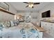 Spacious main bedroom featuring a decorative bed, ceiling fan, and a glimpse into the ensuite bathroom at 7890 Ashford Dr, Lakeland, FL 33810