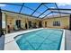 Inviting screened pool area with ample seating and lounge chairs, perfect for outdoor relaxation and entertaining at 7890 Ashford Dr, Lakeland, FL 33810