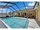 Inviting screened-in pool area with ample seating, perfect for outdoor relaxation and entertaining at 7890 Ashford Dr, Lakeland, FL 33810