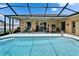 Inviting pool area with a covered lanai, comfortable seating, and a sparkling blue pool at 7890 Ashford Dr, Lakeland, FL 33810