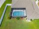 Aerial view of a screened pool, lush backyard and landscaped garden at 7890 Ashford Dr, Lakeland, FL 33810