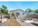 Backyard featuring a patio, lounge area, partial fence, tub, and minimal maintenance landscaping at 807 Osceola St, Lakeland, FL 33801