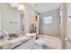 Bathroom featuring stylish vanity, grey tiled walls, and a shower over tub at 807 Osceola St, Lakeland, FL 33801
