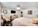 Cozy bedroom with a black floral rug, upholstered chair, TV and soft lighting at 807 Osceola St, Lakeland, FL 33801