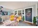 Cozy front porch featuring egg chairs, a colorful rug, and a black front door at 807 Osceola St, Lakeland, FL 33801