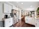 Bright open concept kitchen with stainless steel appliances, white cabinets, granite counters and hardwood flooring at 807 Osceola St, Lakeland, FL 33801