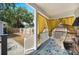 Comfortable porch with stylish furniture, rug, and yellow curtains for privacy, offering an inviting outdoor space at 807 Osceola St, Lakeland, FL 33801