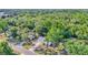 An aerial view shows this home nestled among mature trees in a peaceful, wooded setting at 819 Swann Dr, Lakeland, FL 33809