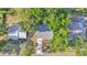 Birds-eye view of a home featuring a well-maintained roof, driveway, and mature trees at 819 Swann Dr, Lakeland, FL 33809