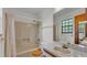 Bathroom with a shower/tub combo, a standard toilet, and single sink vanity at 819 Swann Dr, Lakeland, FL 33809