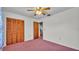 Bedroom with ceiling fan and view into hallway features closet at 819 Swann Dr, Lakeland, FL 33809