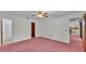 Bedroom with a ceiling fan, neutral wall color and access to the bathroom at 819 Swann Dr, Lakeland, FL 33809