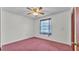 Simple bedroom features neutral walls, ceiling fan, window, and closet at 819 Swann Dr, Lakeland, FL 33809