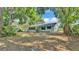 Single-story home surrounded by mature trees and a lawn at 819 Swann Dr, Lakeland, FL 33809