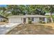 Charming single-story home with a well-maintained lawn and attached two-car garage at 819 Swann Dr, Lakeland, FL 33809