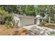 Ranch-style home with attached garage and concrete driveway at 819 Swann Dr, Lakeland, FL 33809