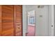 Hallway looking into bedroom features wood closet door at 819 Swann Dr, Lakeland, FL 33809