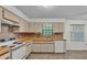 Functional kitchen featuring bright cabinets, laminate countertops, and updated appliances at 819 Swann Dr, Lakeland, FL 33809