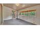 Enclosed lanai with a carpeted floor and multiple windows letting in natural light at 819 Swann Dr, Lakeland, FL 33809