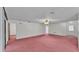 Expansive living room features neutral walls, ceiling fan, and multiple doorways at 819 Swann Dr, Lakeland, FL 33809