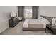 Modern bedroom featuring a gray bed frame, TV, and neutral decor providing a serene and relaxing atmosphere at 860 Killarney Ln, Auburndale, FL 33823