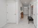 Inviting hallway with decorative accents, tile floors, and neutral wall paint at 860 Killarney Ln, Auburndale, FL 33823