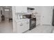 Bright kitchen featuring white cabinetry, granite countertops, and stainless-steel appliances at 860 Killarney Ln, Auburndale, FL 33823