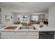 Contemporary kitchen open to the living room and featuring sleek countertops and modern appliances at 860 Killarney Ln, Auburndale, FL 33823