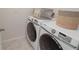 Modern laundry room boasts a newer Samsung washer and dryer set with stylish storage solutions at 860 Killarney Ln, Auburndale, FL 33823